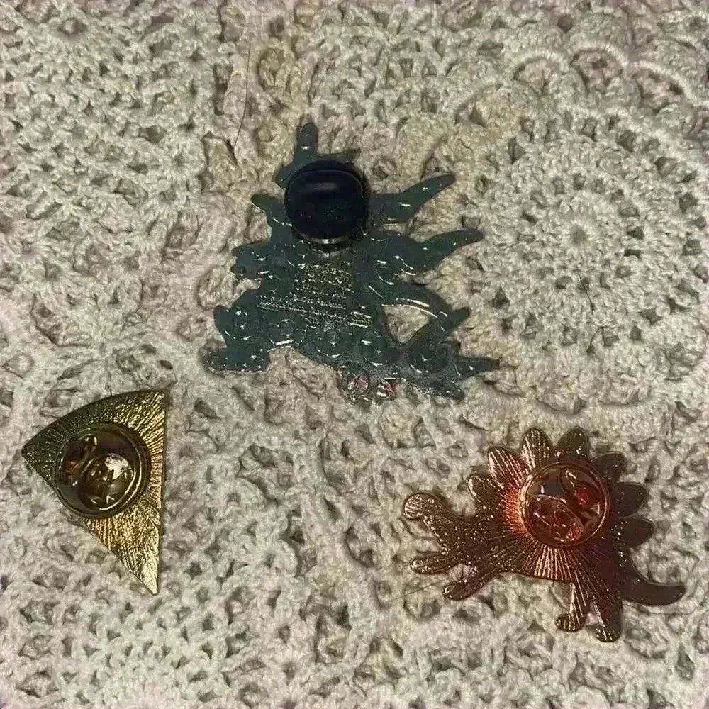 Novelty pin lot, including 1 Pokémon pin